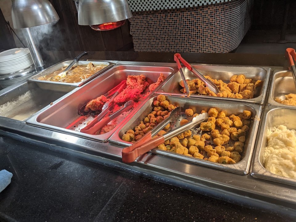 Rows of hot dishes on a buffet line
